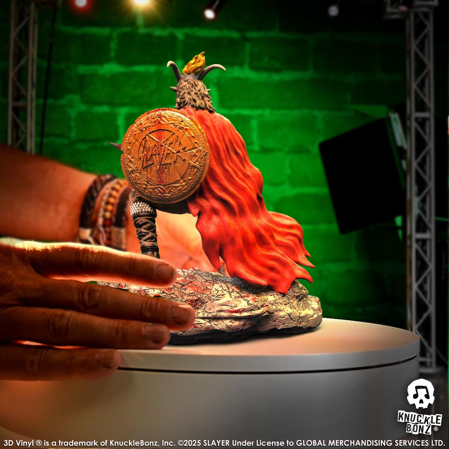 Statue of the Slayer Show No Mercy statue with a sword and shield, featuring the Slayer logo with a green background